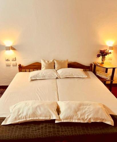 a bedroom with a white bed with two pillows at MarariBeachLaVista1 in Alleppey