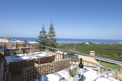 a balcony with a table with a view of the ocean at Carme Villas in Adelianos Kampos