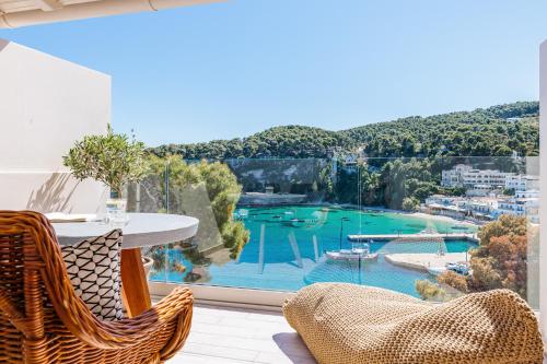 a balcony with a table and chairs and a view of a harbor at Casa Nina in Patitiri