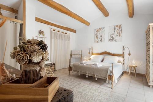 a large bedroom with a bed and a table at Le Mas de la Rode in Saumane