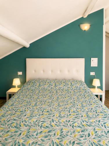 a bedroom with a large bed with a blue wall at Casa di Clara in Rapallo