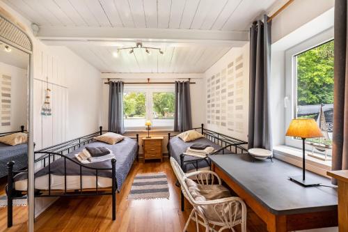a bedroom with two beds and a table at Ferienhaus Bondelum in Bondelum