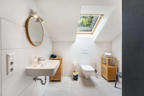 a bathroom with a sink and a mirror and a toilet at Ferienhaus Bondelum in Bondelum