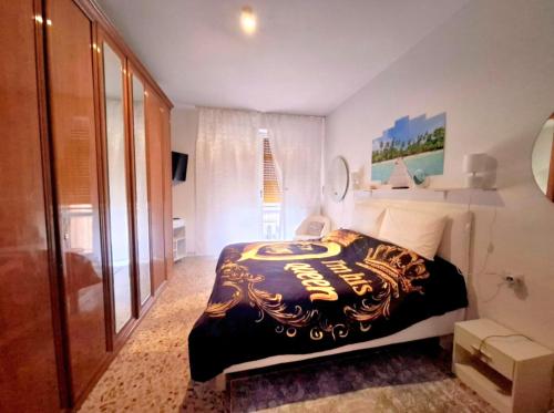 a bedroom with a bed with a black and gold blanket at Luino Flowers Home in Luino