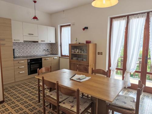 a kitchen and dining room with a wooden table at Apartment Villa Martinelli-1 by Interhome in Crone