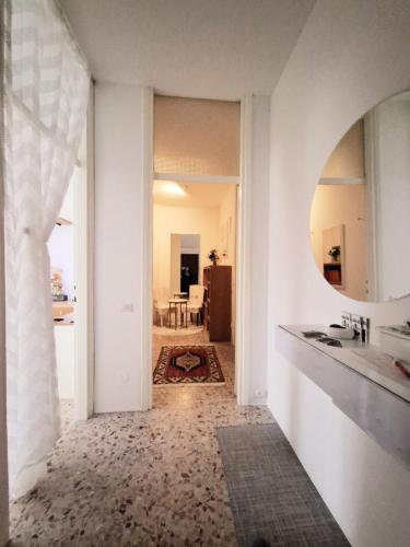 a hallway with a sink and a mirror at Luino Flowers Home in Luino