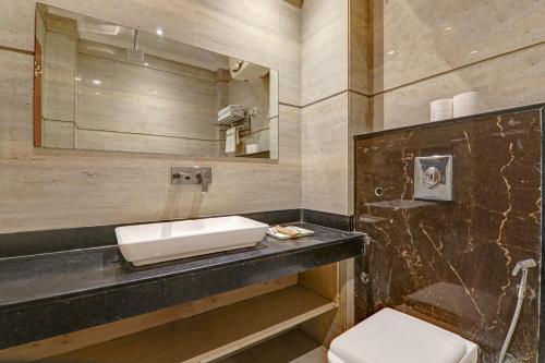 a bathroom with a sink and a toilet at Hotel Luxury Villa - Near IGI Airport Mahipalpur New Delhi in New Delhi