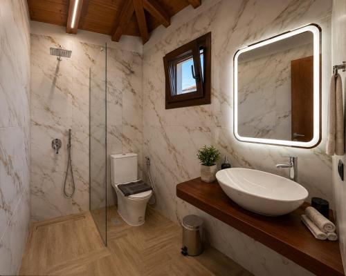 a bathroom with a sink and a glass shower at Sergios in Koukounaries