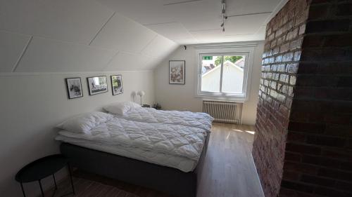 a bedroom with a bed and a window at Dagöholm Gård in Valla