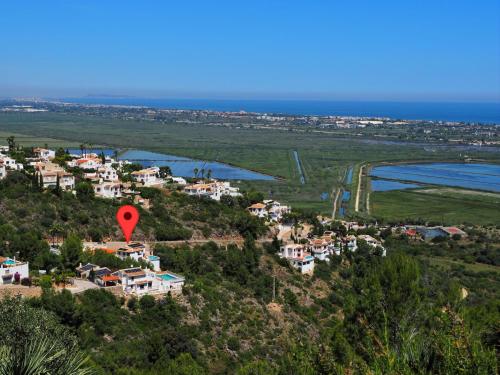 a red balloon flies over a small town on a hill at Holiday Home Del Azahar by Interhome in Monte Pego