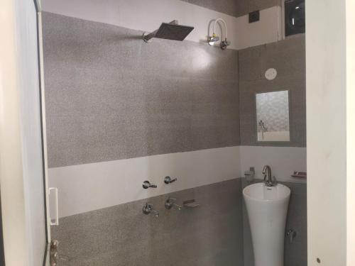 a bathroom with a toilet and a sink at Hotel Aqua Waterfall in Dharamshala