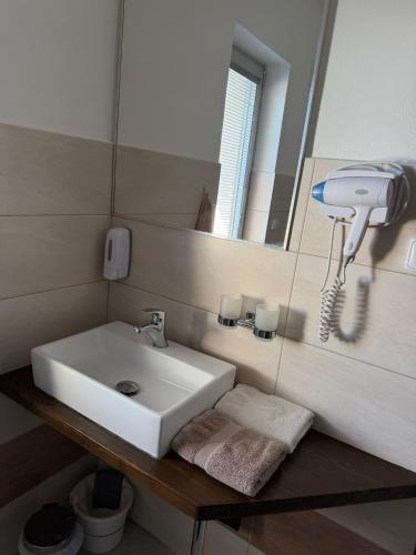 a bathroom with a white sink and a mirror at Apartmány Polevsko in Polevsko