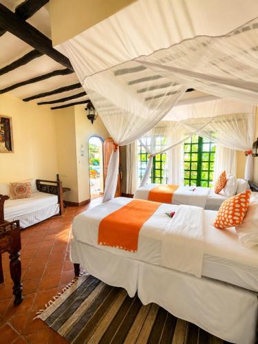a bedroom with two beds in a room at Asha Boutique Hotel in Diani Beach