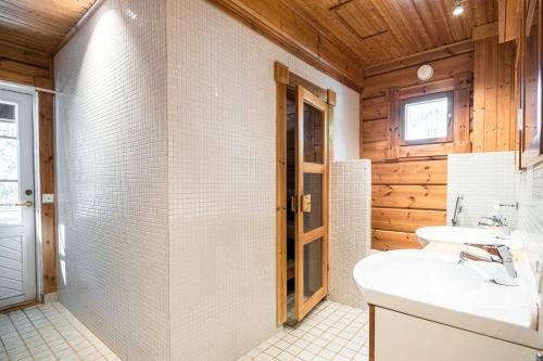 a bathroom with a toilet and a sink at Koivulankaari 17 in Tahkovuori