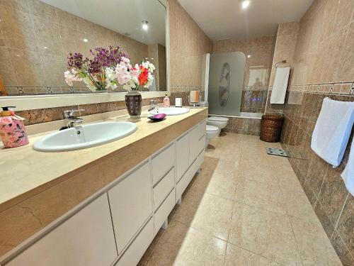a large bathroom with a sink and a toilet at House TAMARIT PLAYA in Tarragona