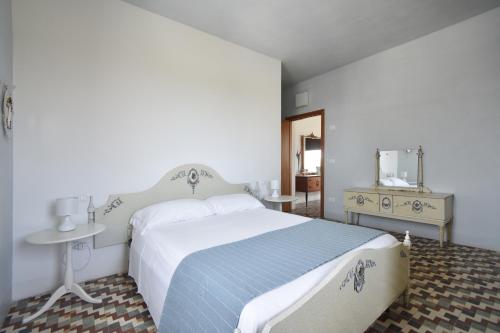 a bedroom with a large white bed and a table at Monti d'Abruzzo in Crecchio
