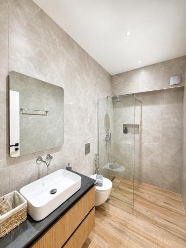 a bathroom with a sink and a toilet and a shower at Nefonas Guest House in Skiathos