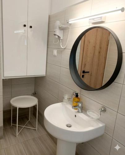 a bathroom with a white sink and a mirror at Electra Gaios Apartment in Gaios
