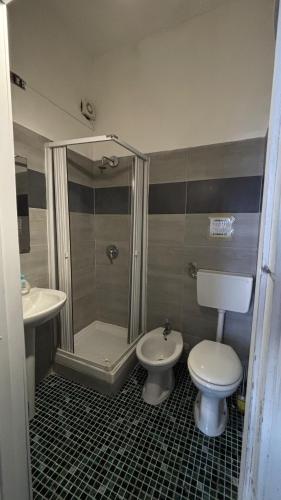 a bathroom with a shower and a toilet and a sink at Sunset hostel Palermo in Palermo