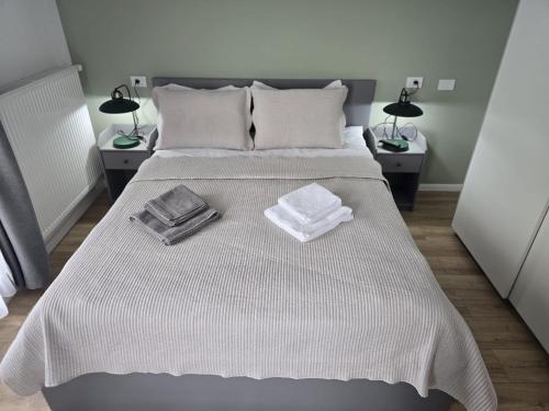 a bedroom with a bed with two towels on it at Apartament My Room in Curtea de Argeş