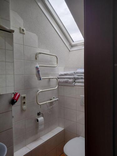 a bathroom with a shower and a toilet and towels at Haus Schober in Windischgarsten