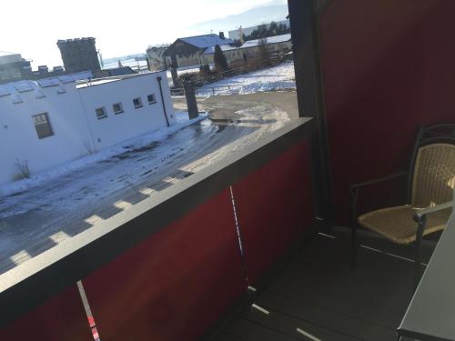 a view from a window of a snow covered roof at Burg Rooms - 24h Self-Check-in in Spielberg