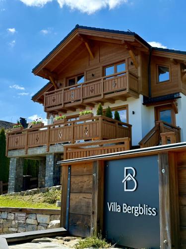a house with a deck on top of a building at Villa Bergbliss in Bukovel