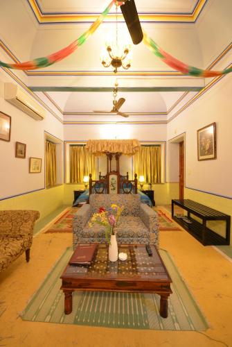 a living room with a couch and a table at Koolwal Kothi Zinc Journey by The Fern, Nawalgarh, Rajasthan in Nawalgarh