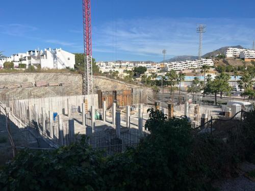 a construction site with a crane in a city at Hotel Nerja Club by Dorobe in Nerja