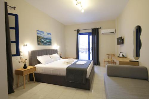 a bedroom with a bed and a chair in a room at Mochlos Studios in Mochlos
