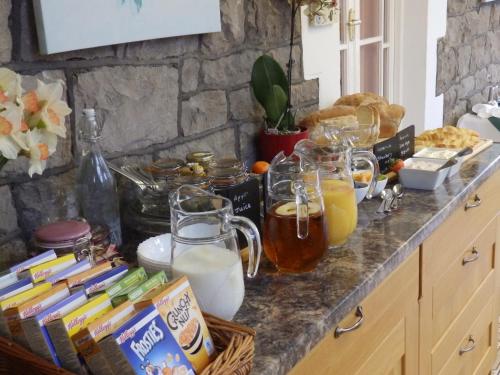 a kitchen counter with a bunch of food and drinks at Linden Lodge Guest House in Weston-super-Mare