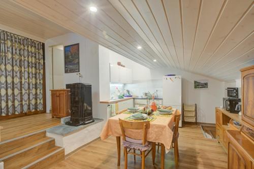 a kitchen with a table with chairs and a stove at Ca Contina in Val Verzasca - Happy Rentals in Frasco