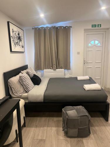 a bedroom with a large bed and a window at Brigstock 9 in Thornton Heath