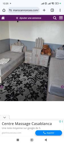 a picture of a bedroom with two beds and a website at Dar ojkak in Essaouira