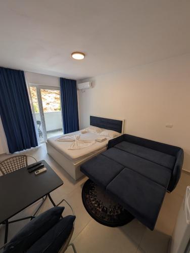 a small room with a bed and a couch at Studio apartment LISI 2 in Lezhë
