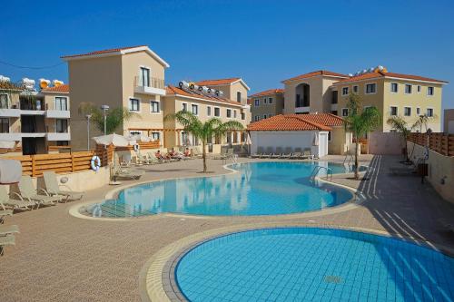 a large swimming pool in the middle of a building at Kyklades Resort & Spa in Paralimni