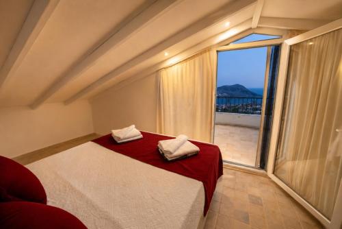 a bedroom with a bed and a large window at Villa Yagmur in Kalkan