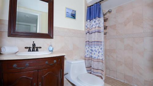 a bathroom with a toilet and a sink and a shower at B105 Moon Bay in Key Largo