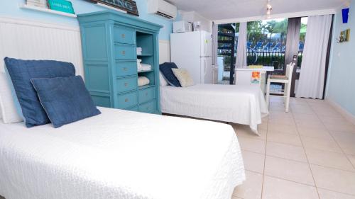 a bedroom with two beds and a blue cabinet at B105 Moon Bay in Key Largo