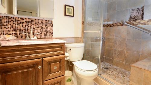 a bathroom with a toilet and a shower and a sink at B405 Moon Bay in Key Largo