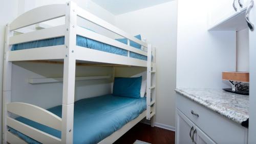 a bunk bed in a small room with blue pillows at B405 Moon Bay in Key Largo