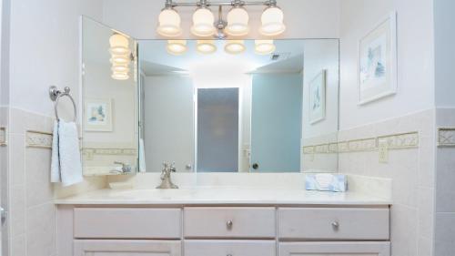a bathroom with a sink and a large mirror at C14 Moon Bay in Key Largo