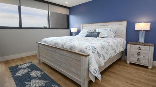 a bedroom with a bed and a blue wall at A409 Moon Bay in Key Largo