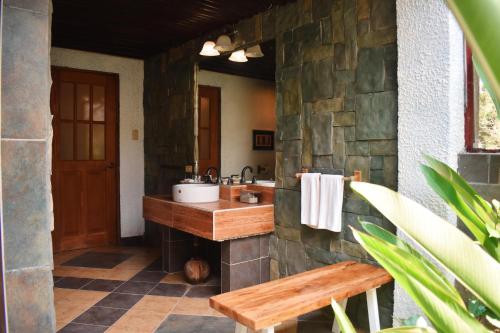 a bathroom with a sink and a stone wall at M Villa’s Farm Resort in Romblon