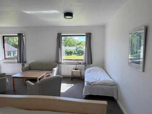 a living room with a couch and a table at Emmaus Hostel in Haslev