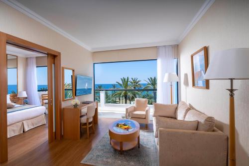 a living room with a room with a view of the ocean at Constantinou Bros Asimina Suites Hotel in Paphos