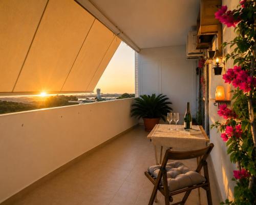 a balcony with a table and a view of the city at Gate 10 - Bari Airport Apartment in Bari