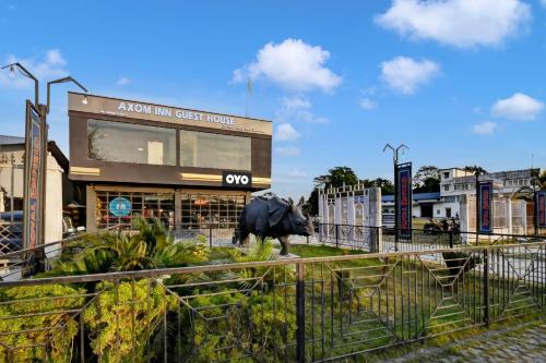 a statue of a bull in front of a building at Hotel O Axom Inn in Barpeta