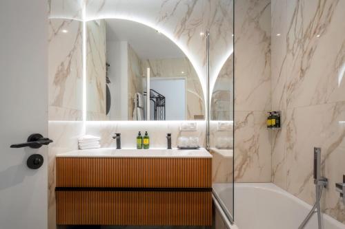 a bathroom with a sink and a shower at Montmartre Residence in Paris