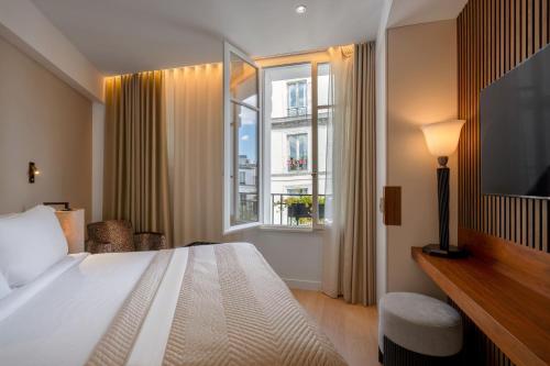 a bedroom with a large bed and a window at Montmartre Residence in Paris